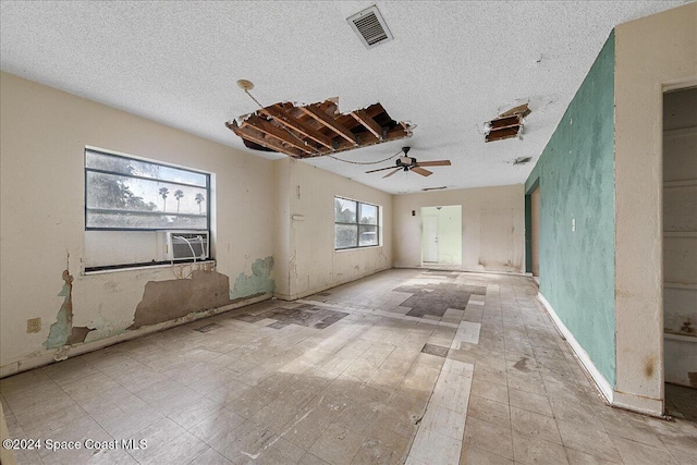 spare room with ceiling fan and a textured ceiling