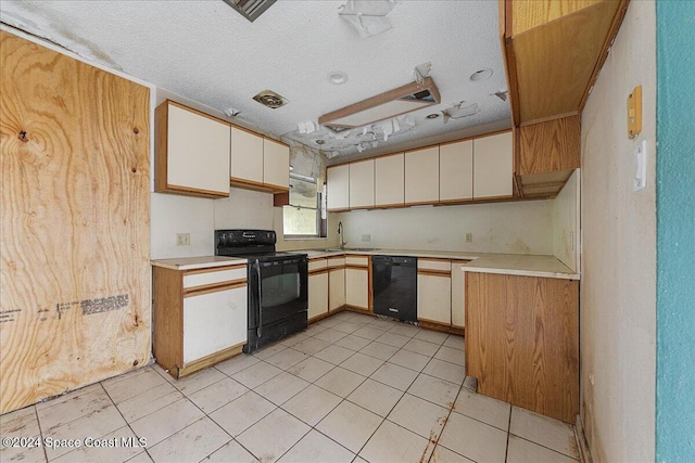 kitchen with black appliances, sink, and a textured ceiling