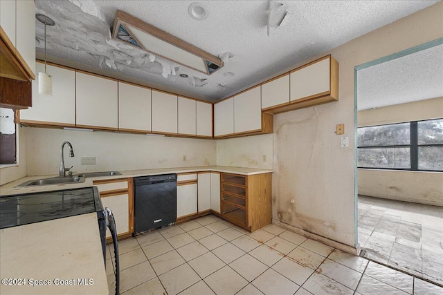 kitchen featuring sink, black dishwasher, pendant lighting, white cabinets, and range