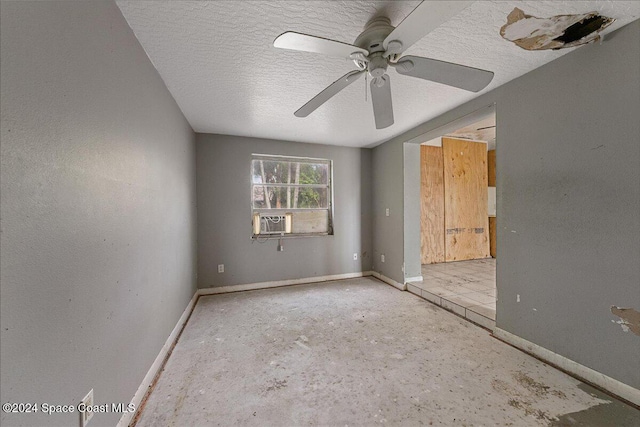 spare room featuring a textured ceiling, ceiling fan, and cooling unit