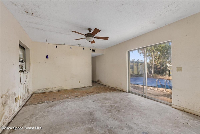 spare room featuring ceiling fan and a textured ceiling