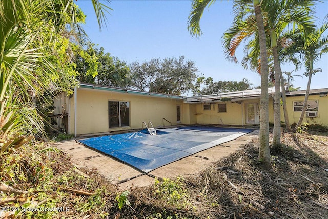 exterior space with a patio area and a covered pool