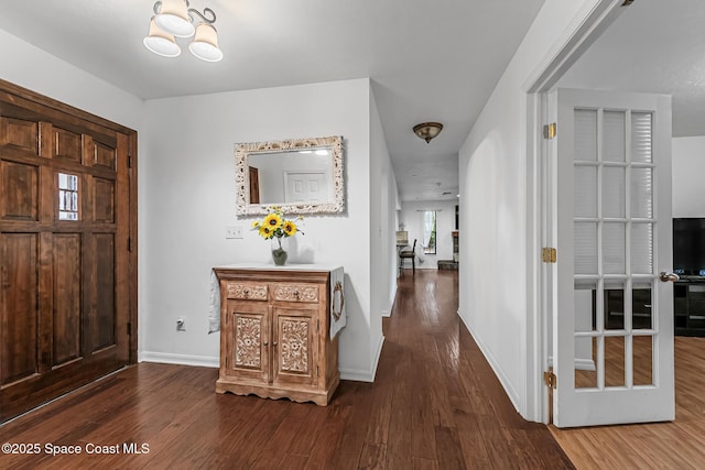 foyer entrance featuring hardwood / wood-style floors and a notable chandelier