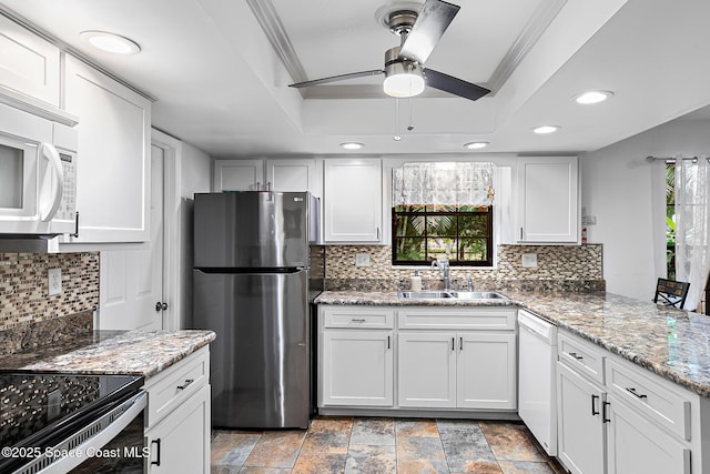 kitchen featuring white cabinetry, sink, and white appliances