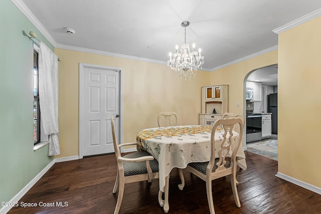 dining room featuring a chandelier, dark hardwood / wood-style flooring, and crown molding