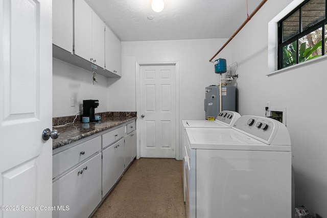 laundry room featuring cabinets, independent washer and dryer, and water heater