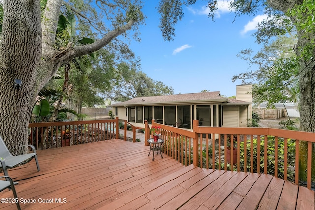 wooden deck with a sunroom