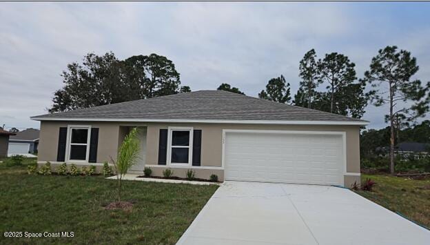 single story home with driveway, an attached garage, a front lawn, and stucco siding