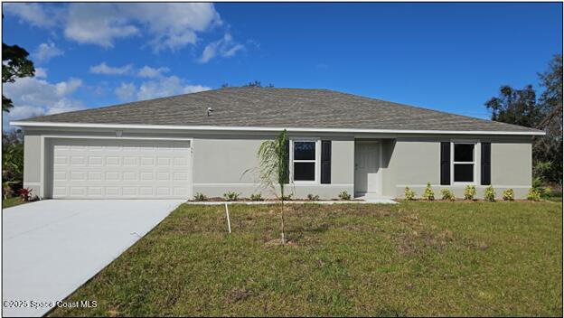 single story home with a garage, a front yard, driveway, and stucco siding