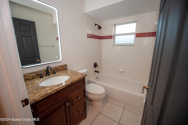 full bathroom featuring toilet, tiled shower / bath, tile patterned floors, and vanity