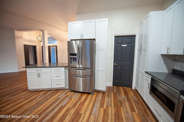 kitchen featuring white cabinets, backsplash, and appliances with stainless steel finishes