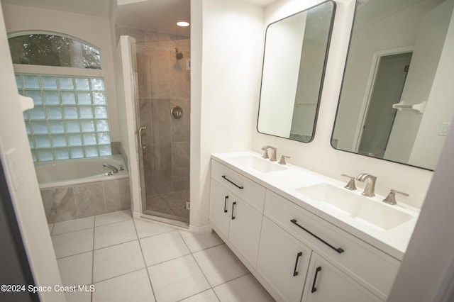 bathroom featuring vanity, tile patterned flooring, and plus walk in shower