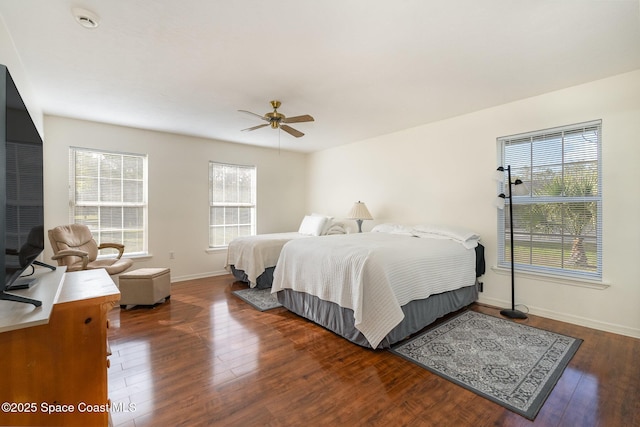 bedroom with multiple windows, ceiling fan, and dark hardwood / wood-style floors