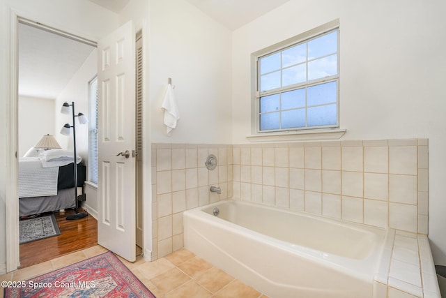 bathroom with tile patterned flooring and a bathing tub