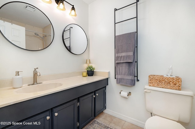 bathroom with tile patterned flooring, vanity, and toilet