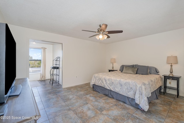 bedroom featuring ceiling fan and a textured ceiling