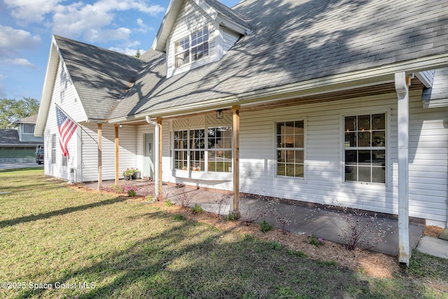 view of side of home with a lawn