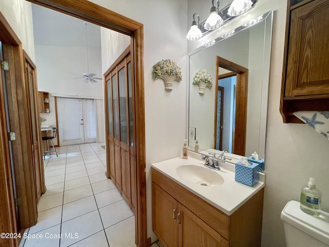 bathroom featuring ceiling fan, tile patterned flooring, vanity, and toilet