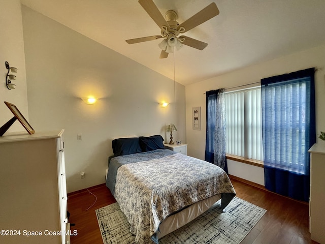 bedroom with dark wood-type flooring, ceiling fan, and lofted ceiling