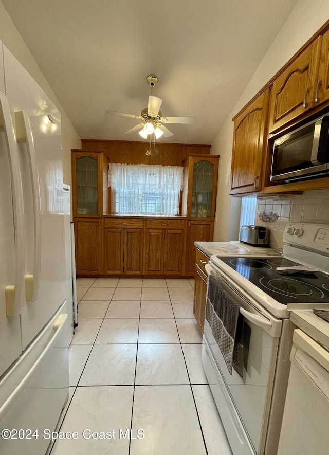 kitchen featuring ceiling fan, white appliances, backsplash, and light tile patterned floors