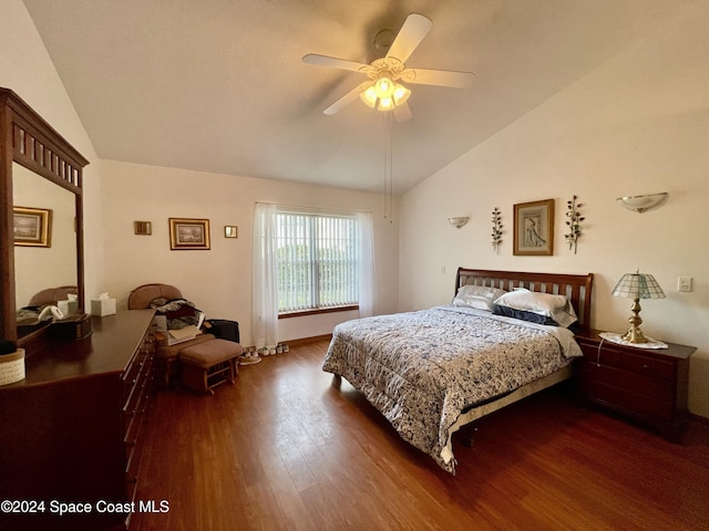 bedroom featuring dark hardwood / wood-style floors, ceiling fan, and lofted ceiling