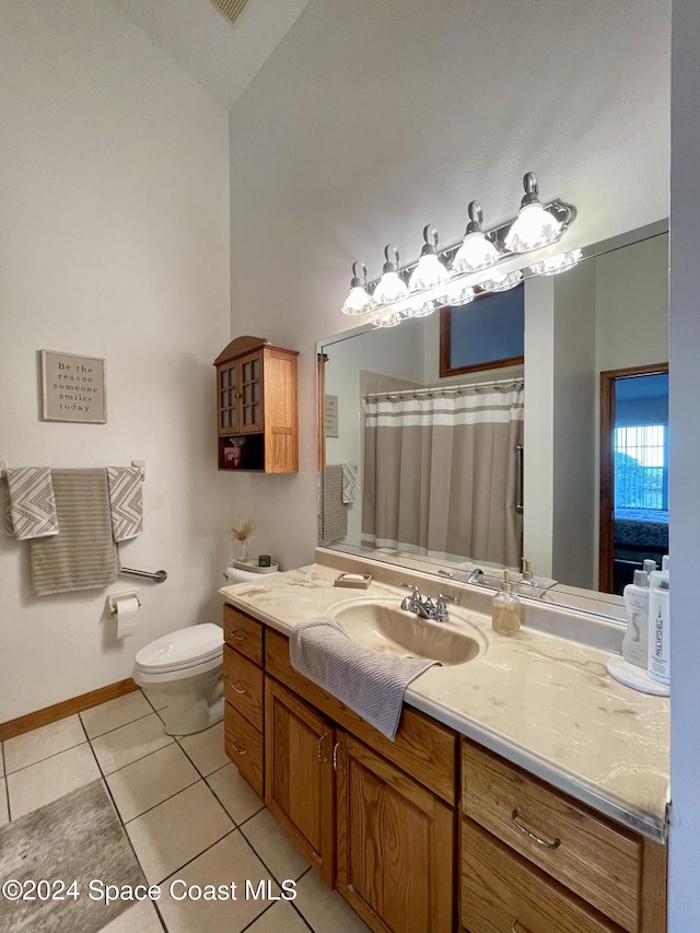 bathroom with tile patterned floors, vanity, and toilet