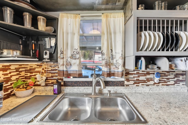 kitchen featuring sink and tasteful backsplash