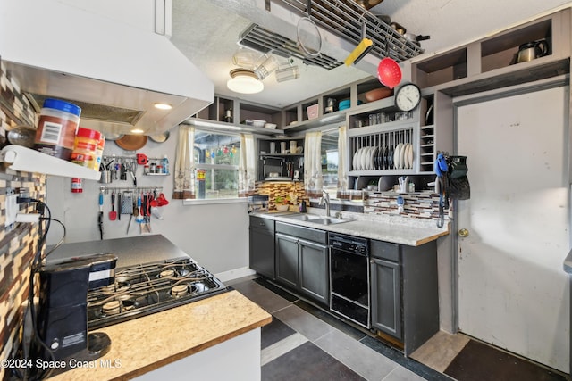 kitchen with gas cooktop, gray cabinetry, a textured ceiling, island range hood, and sink