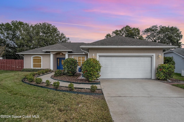 view of front of house with a lawn and a garage