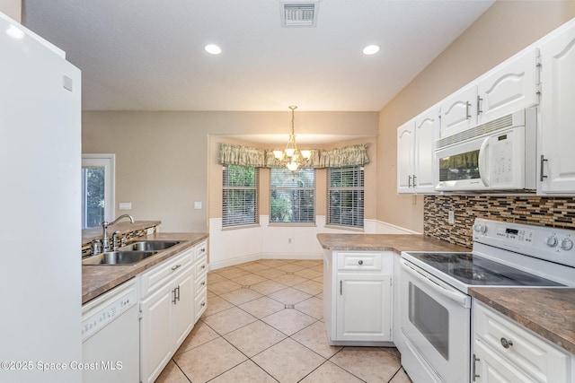 kitchen featuring sink, hanging light fixtures, kitchen peninsula, white appliances, and white cabinets