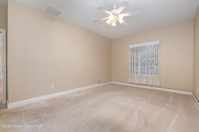 unfurnished room featuring light carpet and ceiling fan