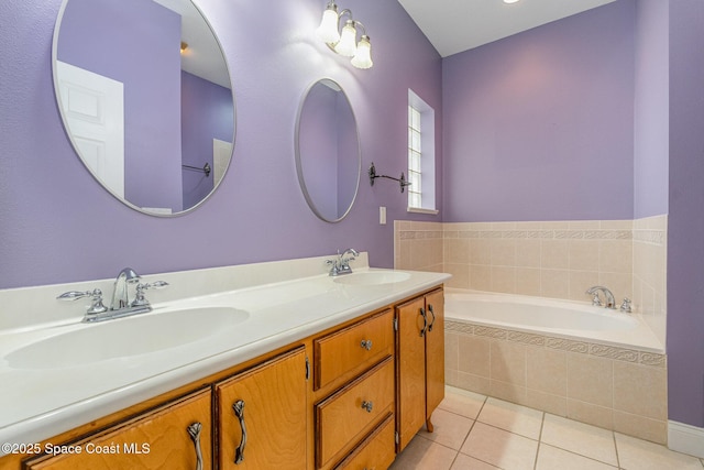 bathroom featuring vanity, tile patterned flooring, and a relaxing tiled tub