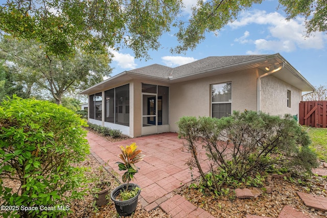 back of house featuring a sunroom and a patio