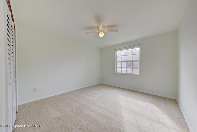 unfurnished room featuring ceiling fan and light colored carpet