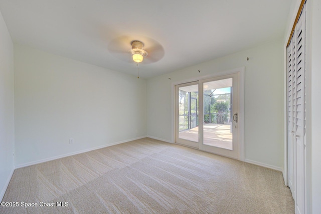 empty room with light carpet and ceiling fan