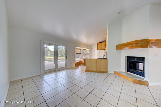 unfurnished living room featuring vaulted ceiling and light tile patterned flooring