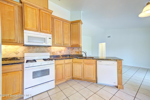 kitchen with kitchen peninsula, white appliances, sink, and light tile patterned floors