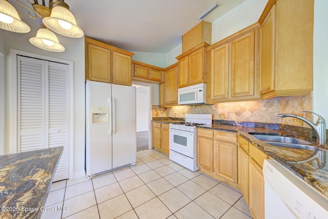 kitchen with sink, hanging light fixtures, backsplash, white appliances, and light tile patterned floors