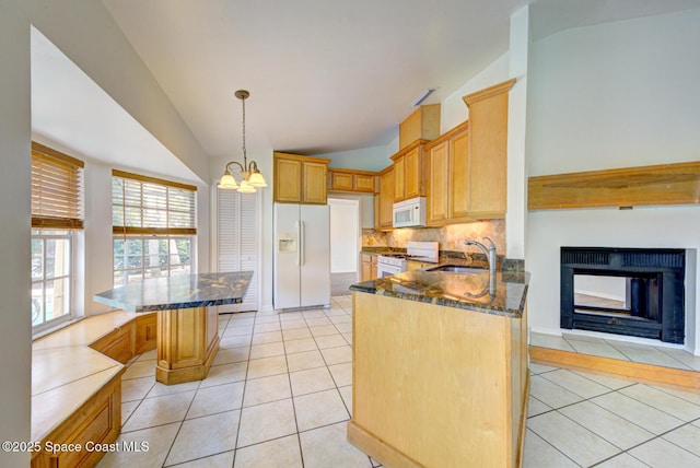 kitchen with light tile patterned flooring, white appliances, sink, and tasteful backsplash