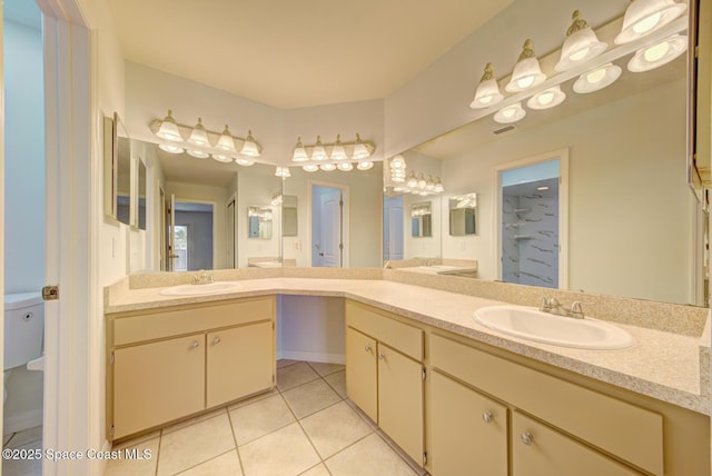 bathroom featuring tile patterned flooring, vanity, and toilet