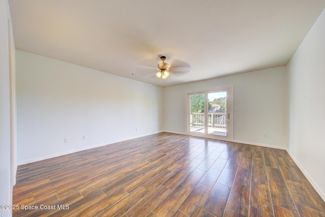 spare room with dark hardwood / wood-style floors and ceiling fan