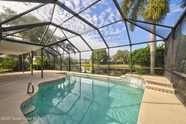 view of swimming pool featuring a patio area, a water view, and glass enclosure