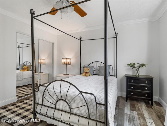 bedroom featuring dark hardwood / wood-style flooring, ceiling fan, and crown molding