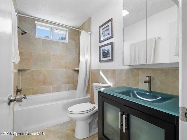 full bathroom featuring vanity, tile patterned flooring, toilet, shower / bath combo with shower curtain, and tile walls