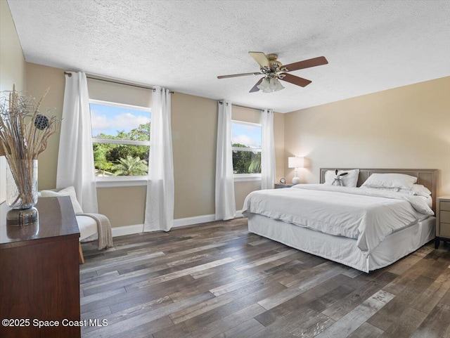 bedroom featuring a textured ceiling, dark hardwood / wood-style floors, and ceiling fan