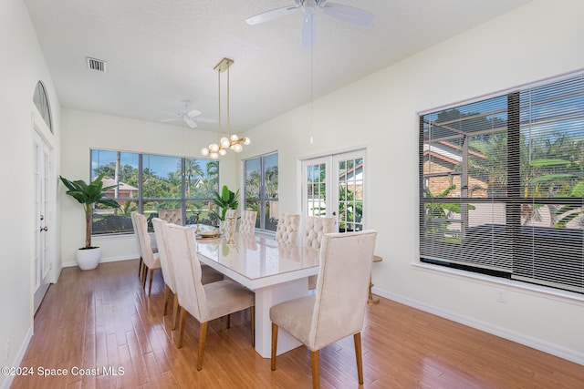 dining space featuring hardwood / wood-style flooring, ceiling fan, a healthy amount of sunlight, and french doors