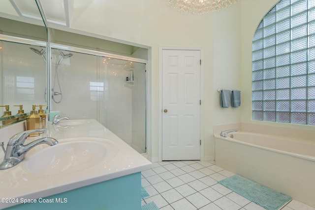 bathroom with a healthy amount of sunlight, tile patterned flooring, vanity, and independent shower and bath