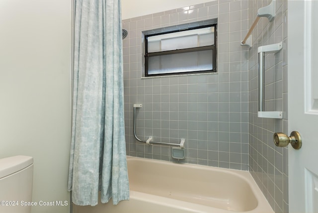 bathroom with toilet and shower / bath combo with shower curtain