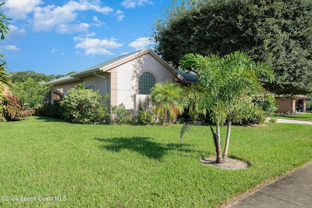 view of property exterior with a lawn