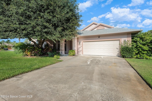 view of front of property with a garage and a front lawn